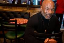 Former boxer Mike Tyson is shown after the unveiling of his statue at Mulberry Street Pizzeria ...