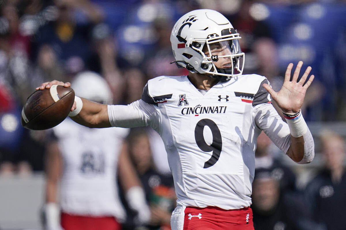 Cincinnati quarterback Desmond Ridder throws a pass against Navy during the first half of an NC ...