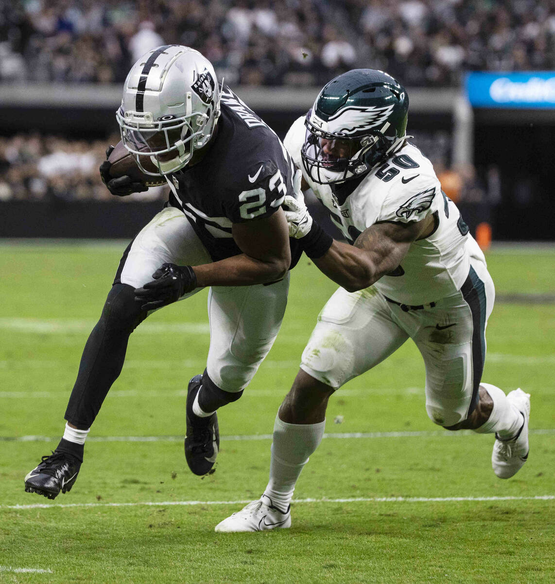 Raiders running back Kenyan Drake (23) chased by Philadelphia Eagles linebacker Eric Wilson (50 ...