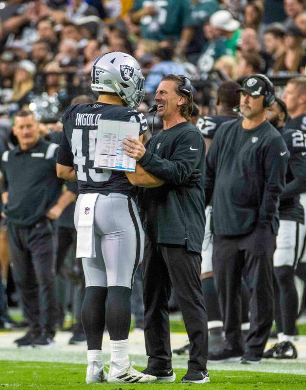 Raiders fullback Alec Ingold (45) celebrates a great play with offensive coordinator Greg Olson ...