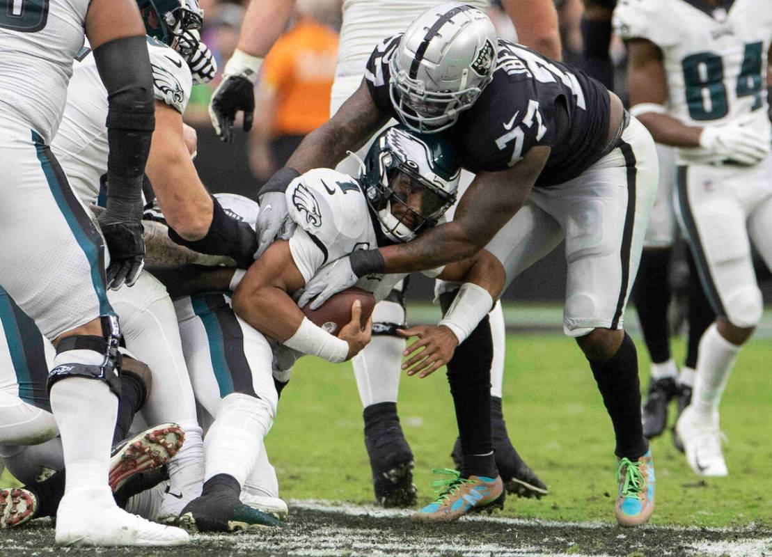 Philadelphia Eagles quarterback Jalen Hurts (1) is sacked by Raiders defensive tackle Quinton J ...