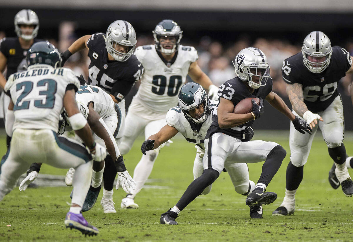 Raiders running back Kenyan Drake (23) cuts up field past Philadelphia Eagles middle linebacker ...