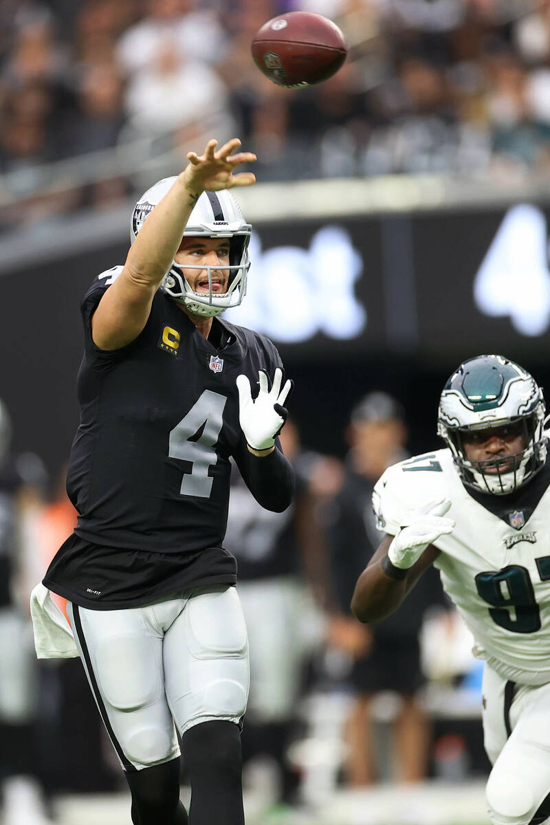 Raiders quarterback Derek Carr (4) throws the ball under pressure from Philadelphia Eagles defe ...