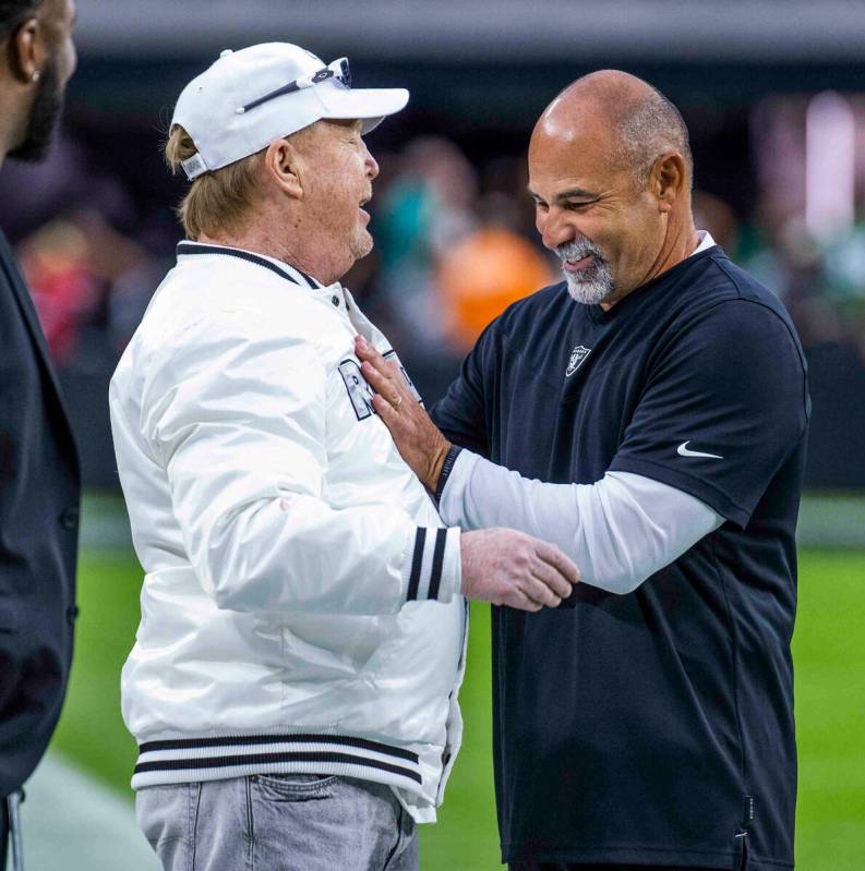 Raiders owner Mark Davis chats with head coach Rich Bisaccia on the field before the first half ...