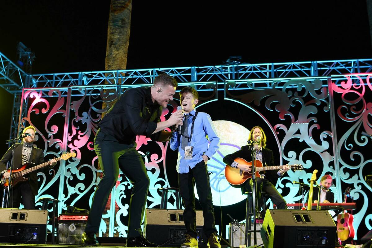 Cooper Sandoval, 12, and Imagine Dragons singer Dan Reynolds perform at Imagine Dragons' sevent ...