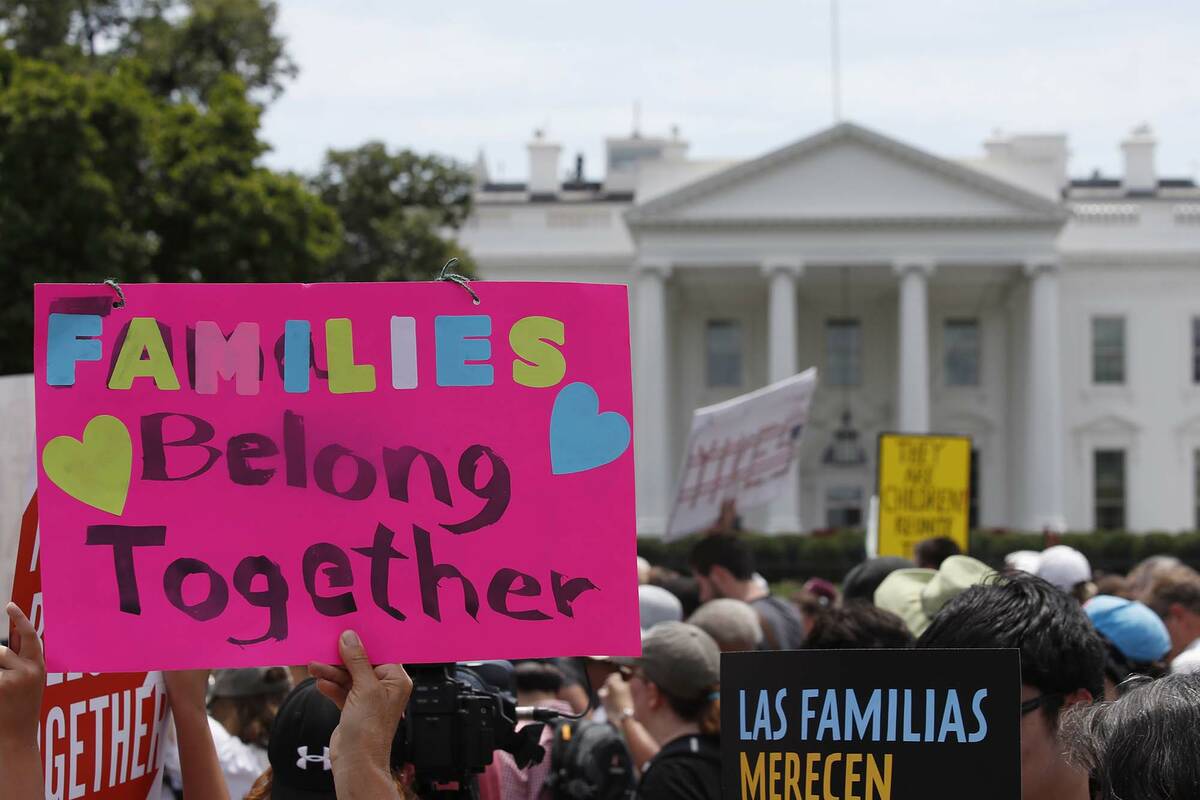 FILE - In this June 20, 2018, file photo, activists march past the White House to protest the T ...