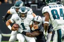 Philadelphia Eagles quarterback Jalen Hurts (1) is sacked by Raiders defensive end Yannick Ngak ...