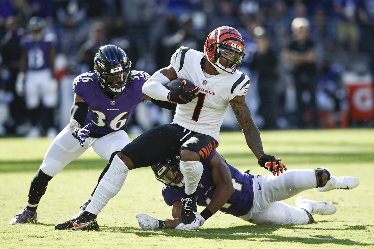 Baltimore Ravens safety Chuck Clark (36) and cornerback Marlon Humphrey (44) miss a tackle of C ...
