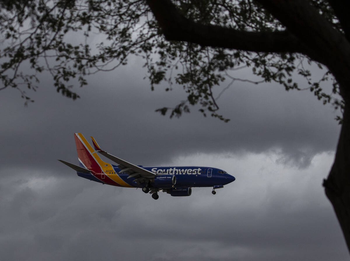 A Southwest Airlines plane prepares to land under a dark sky at McCarran Airport, on Monday, Oc ...