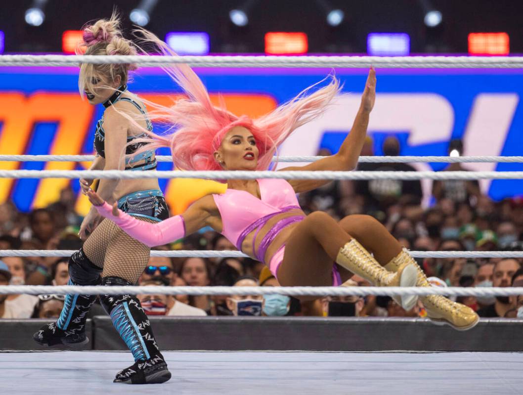 Alexa Bliss , left, upends Eva Marie in their match during WWE SummerSlam 2021 at Allegiant Sta ...