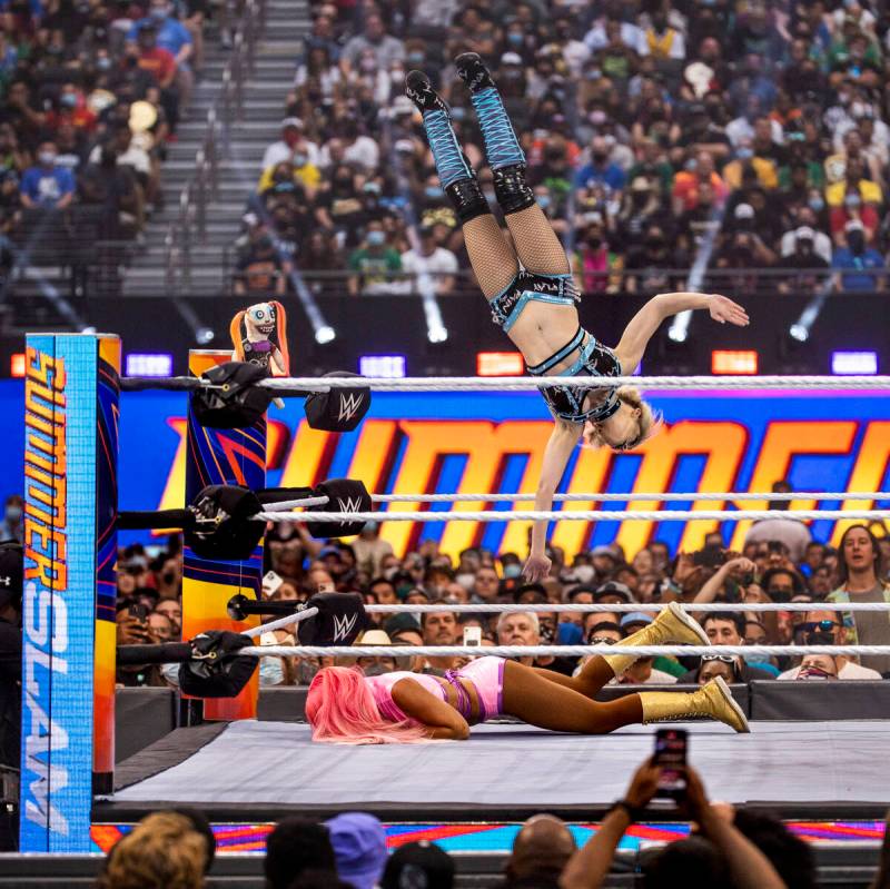 Alexa Bliss dives off the top rope onto Eva Marie in their match during WWE SummerSlam 2021 at ...