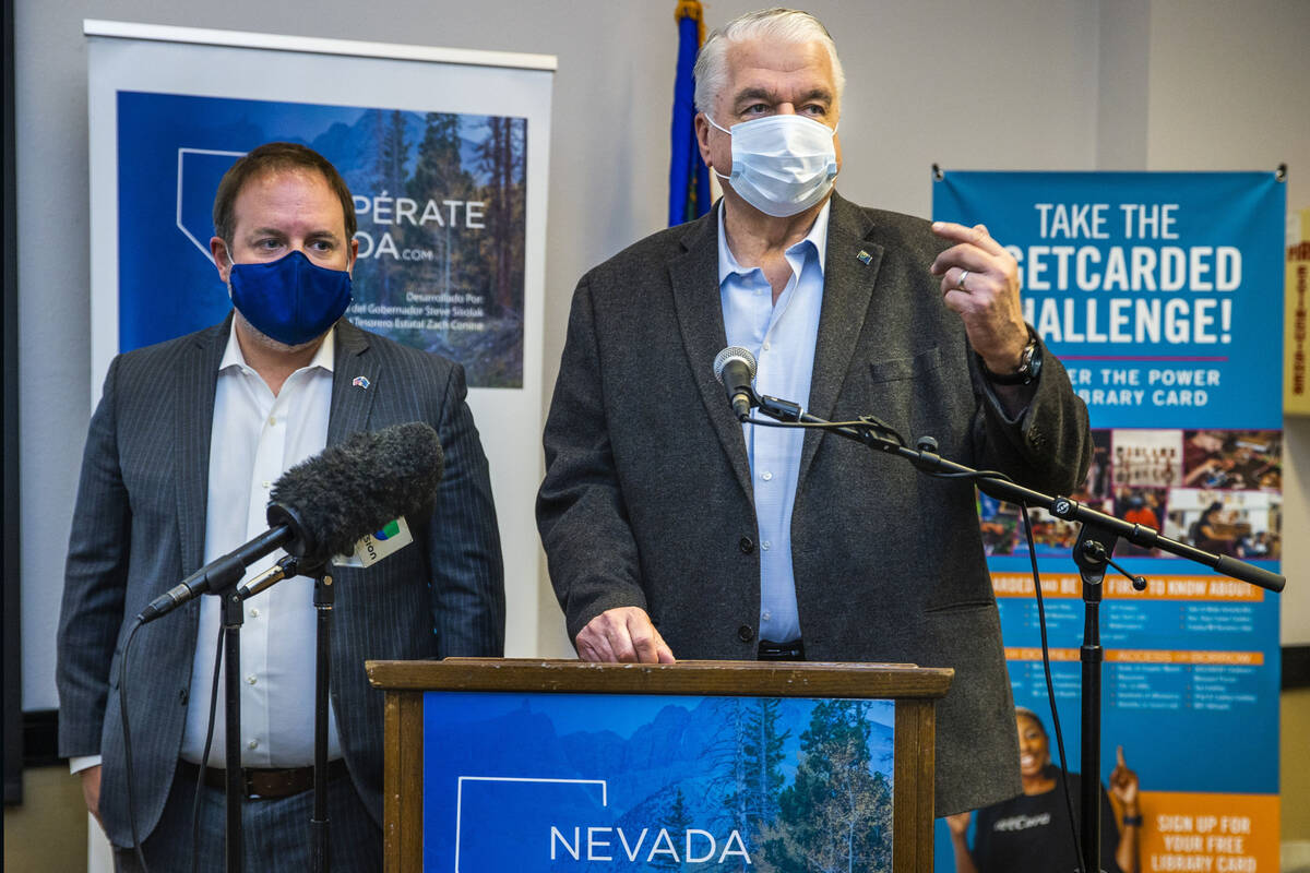 Governor Steve Sisolak, right, speaks beside Nevada Treasurer Zach Conine at the West Las Vegas ...