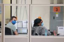 Workers count ballots inside of the Clark County Election Department in North Las Vegas. (Erik ...