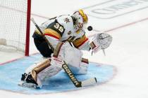 Vegas Golden Knights goaltender Laurent Brossoit has a shot from the Dallas Stars deflect off h ...