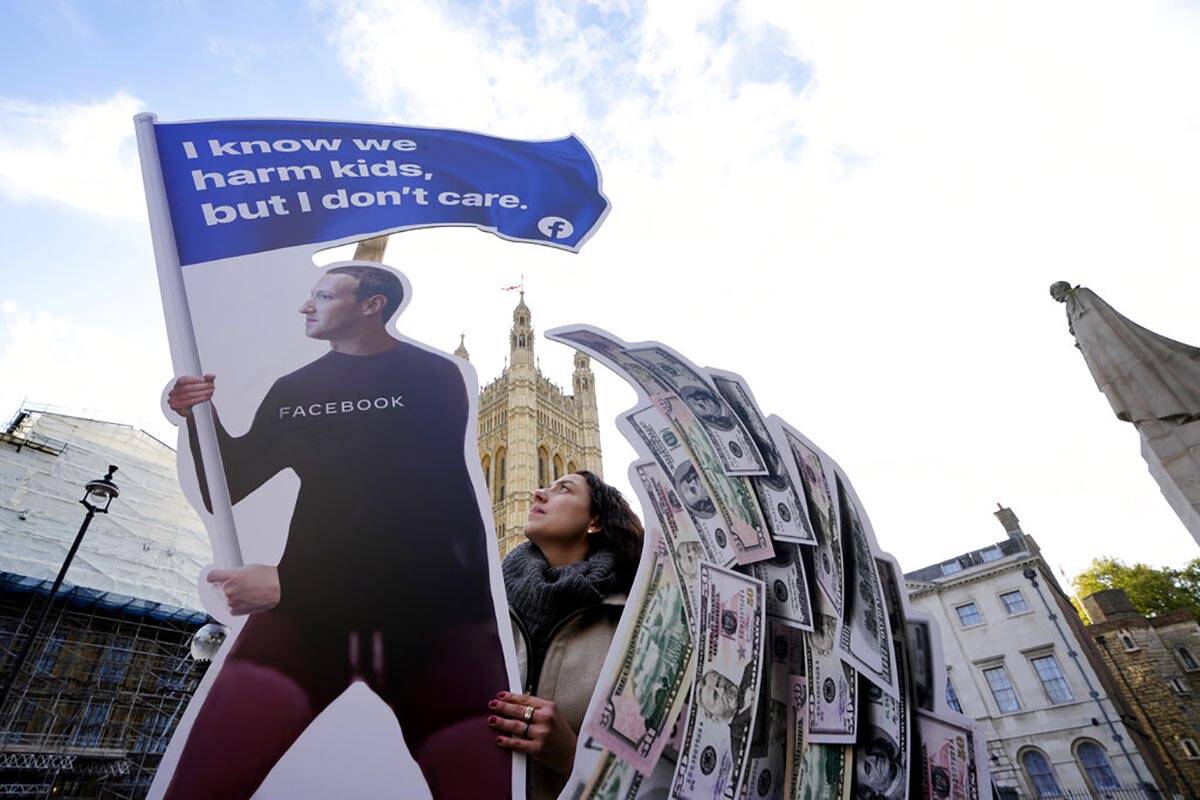 Senior campaigner from SumOfUs Flora Rebello Arduini adjusts an installation outside parliament ...