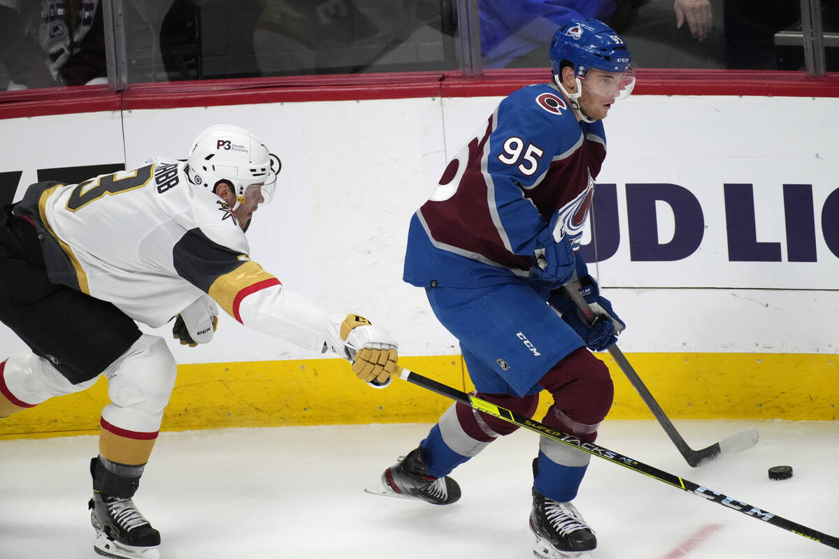 Colorado Avalanche left wing Andre Burakovsky, right, collects the puck as Vegas Golden Knights ...