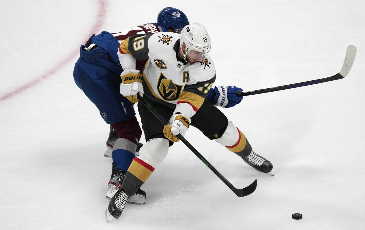 Vegas Golden Knights right wing Reilly Smith, front, is tied up by Colorado Avalanche left wing ...