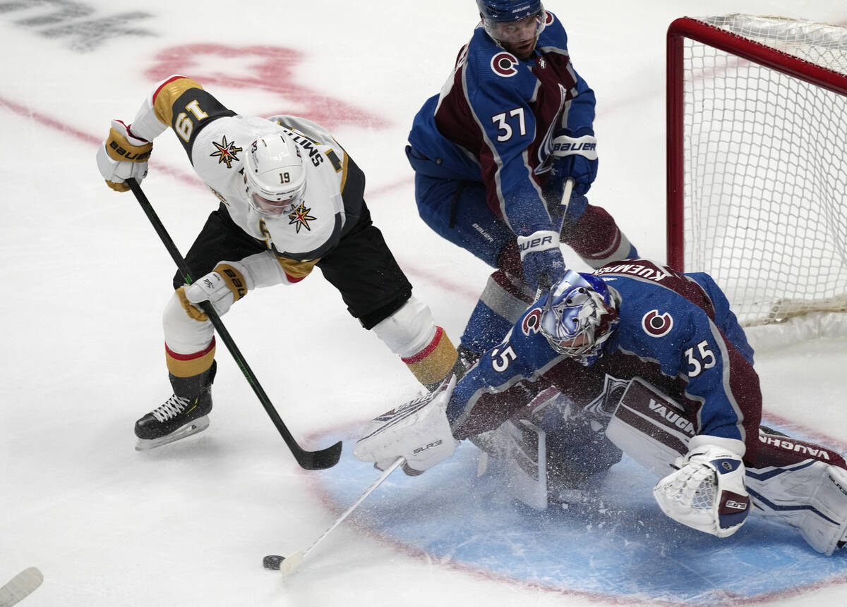 Colorado Avalanche goaltender Darcy Kuemper, right, makes a stick save of a shot by Vegas Golde ...