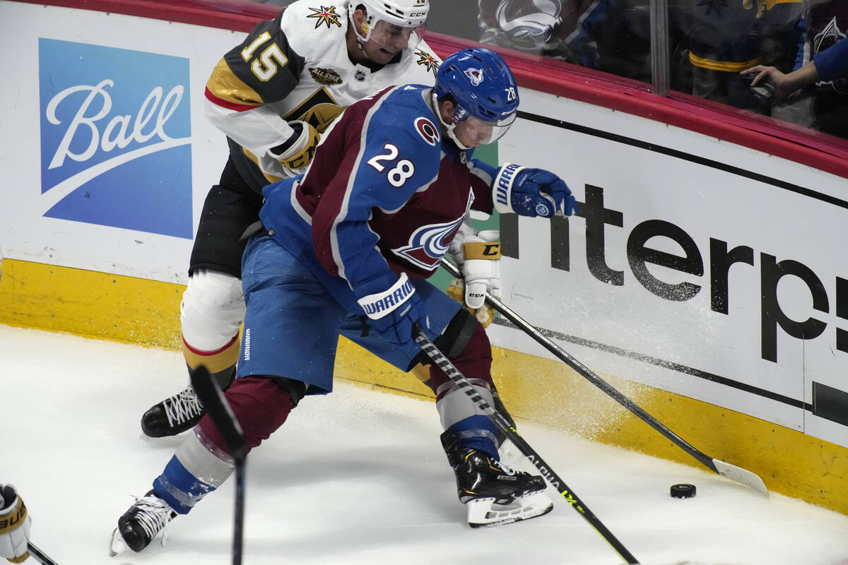 Colorado Avalanche defenseman Ryan Murray, front, fights for control of the puck with Vegas Gol ...