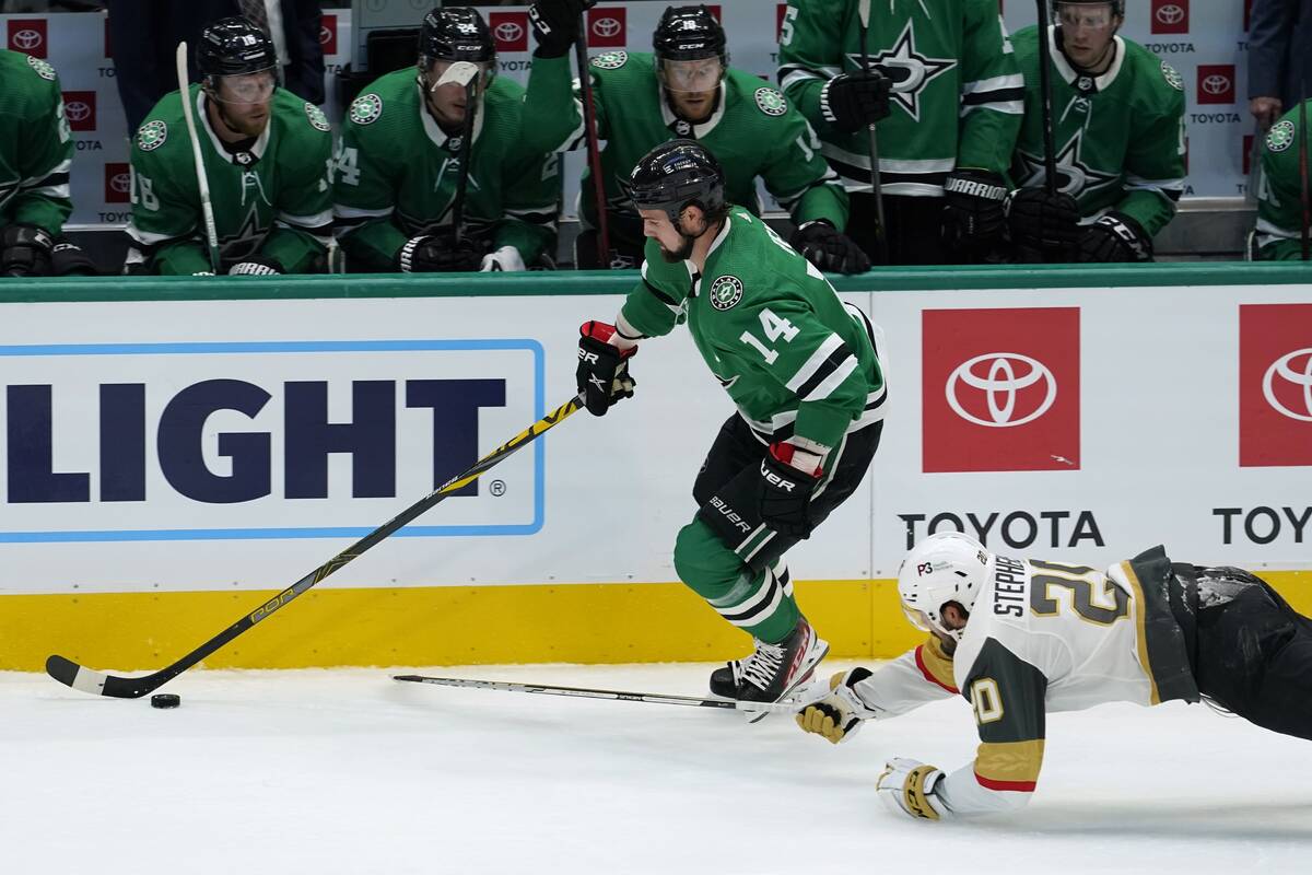 Dallas Stars left wing Jamie Benn (14) controls the puck as Vegas Golden Knights center Chandle ...