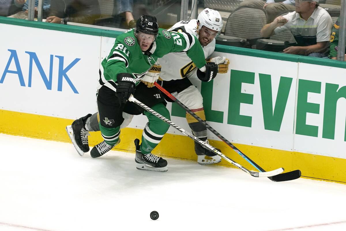 Dallas Stars defenseman Ryan Suter (20) and left wing William Carrier (28) work for control of ...