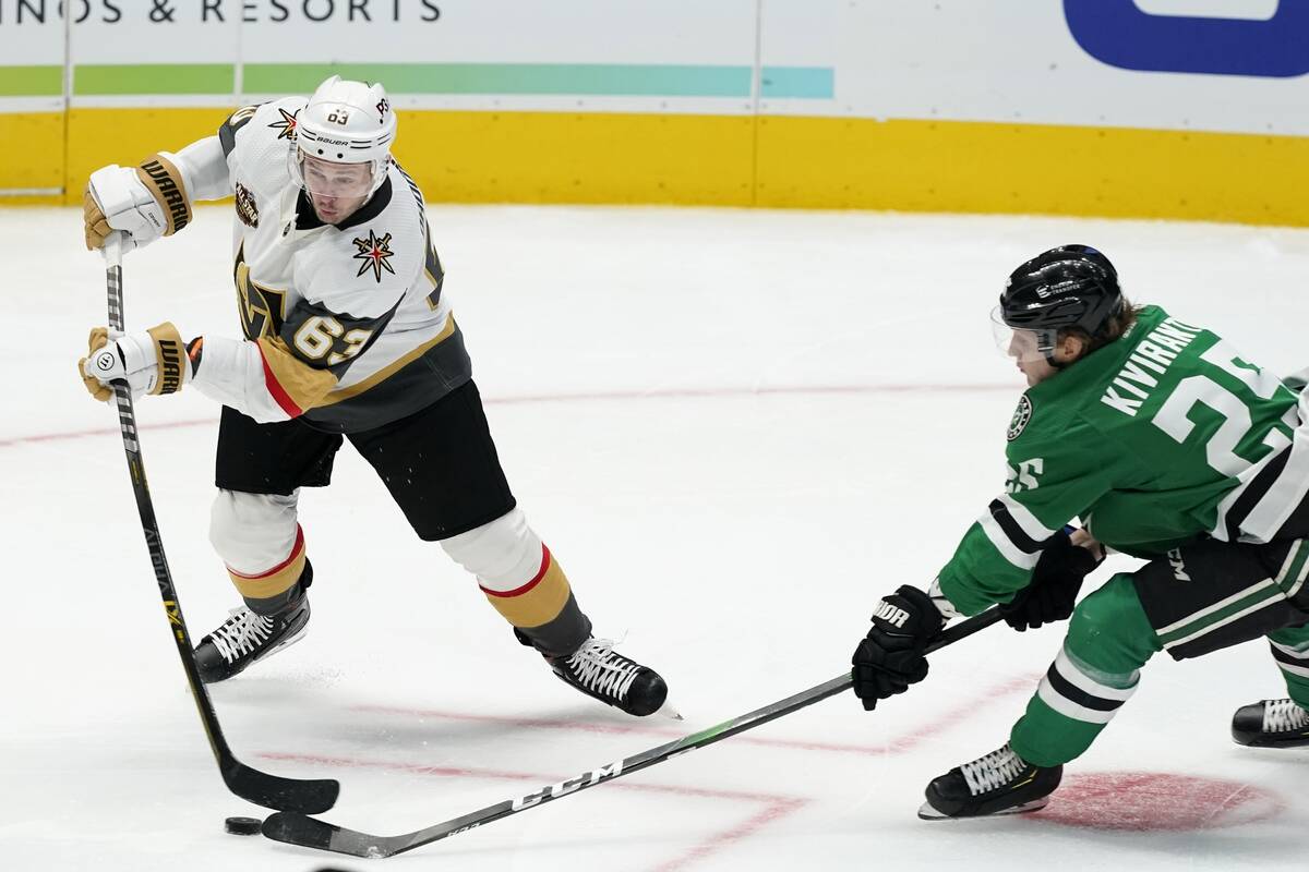 Vegas Golden Knights right wing Evgenii Dadonov (63) has his shot disrupted by Dallas Stars lef ...