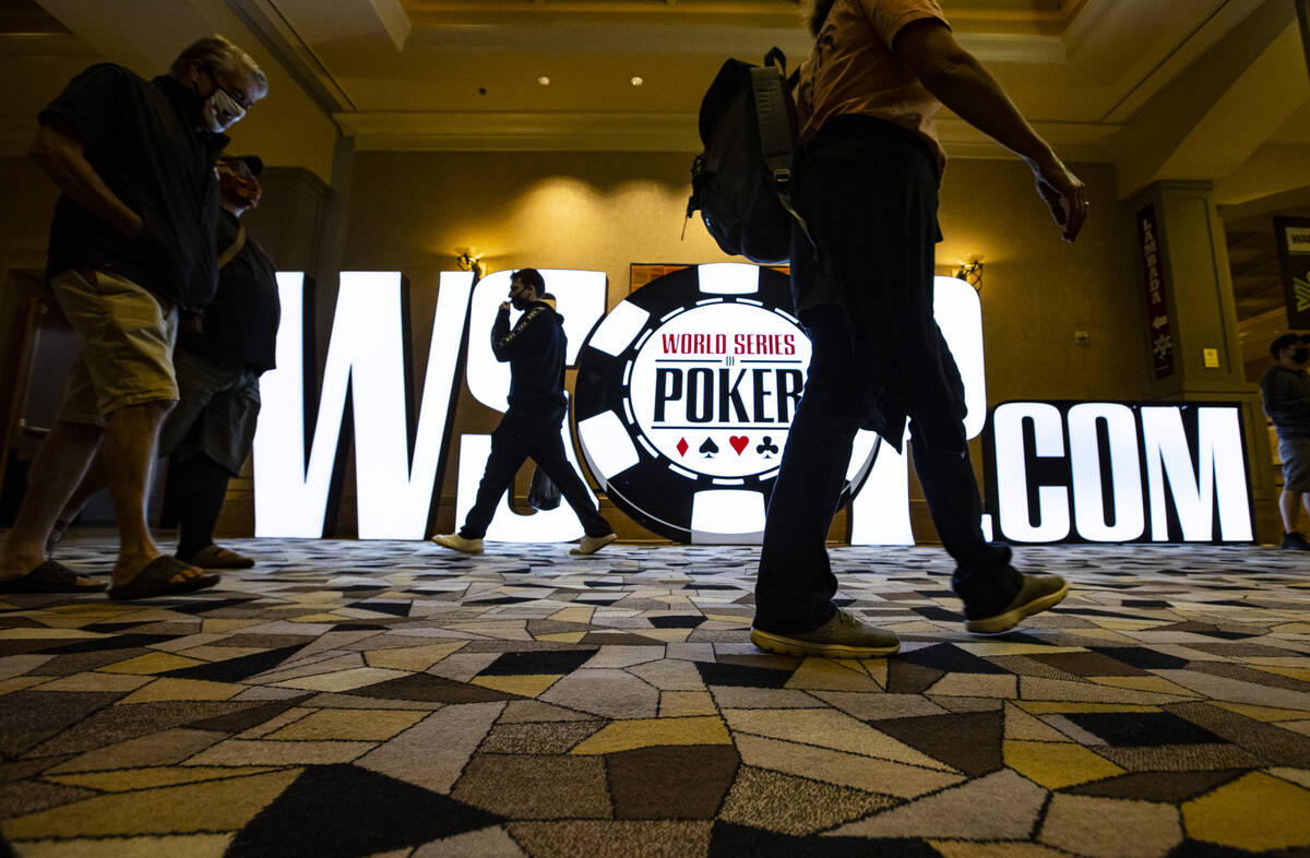People walk by signage for the World Series of Poker at the Rio in Las Vegas on Thursday, Oct. ...