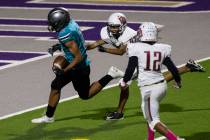 Silverado High running back Donavyn Pellot (2) runs past Desert Oasis slotback Zachary James (8 ...