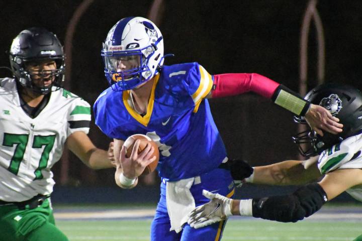 Moapa Valley quarterback Peyton Neilson avoids a sack during the Hammer Game against Virgin Val ...