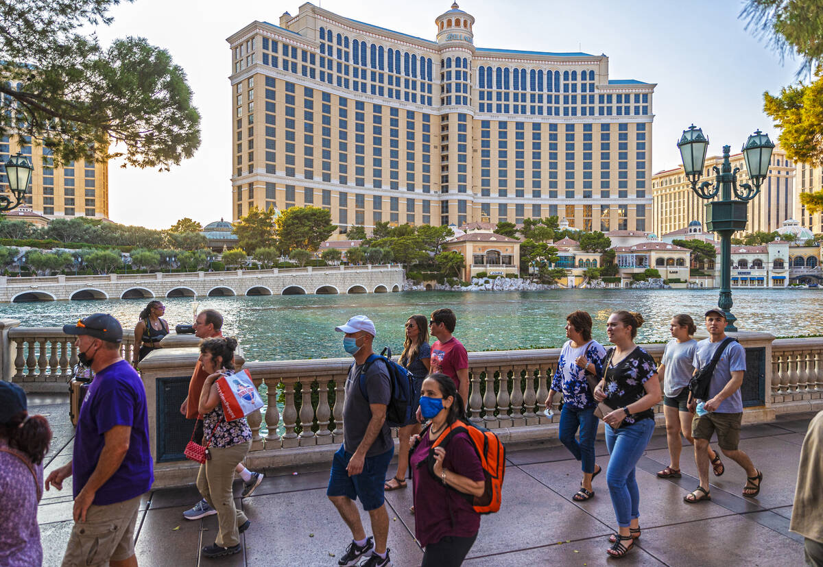 Pedestrians walk past Bellagio on Monday, Sept. 27, 2021, in Las Vegas. (Benjamin Hager/Las Veg ...