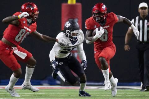 Rebels running back Charles Williams (8) sprints up field past Utah State Aggies safety Monte' ...