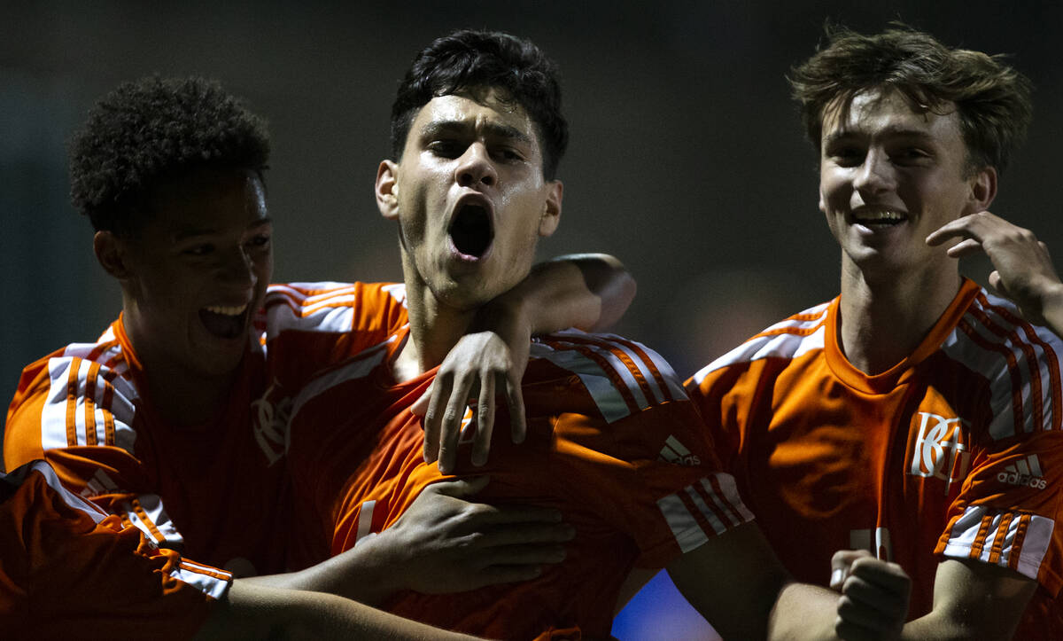 From left, Bishop Gorman's Bronson Rolley (3), Joseph Chami (6) and Braden Flannery (10) celebr ...
