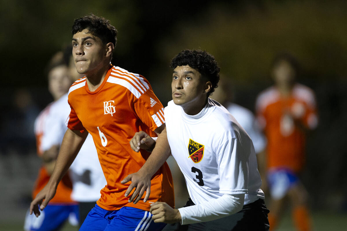 Bishop Gorman's Joseph Chami (6) and Las Vegas' Calvin Lopez (3) eye the ball during a high sch ...