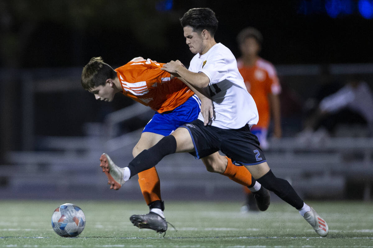 Bishop Gorman's Luke Parker (32) and Las Vegas' Darian Coronel (11) run for the ball during a h ...