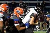 Bishop Gorman’s Aiden McComber sacks Faith Lutheran quarterback Ryan Walter during the f ...