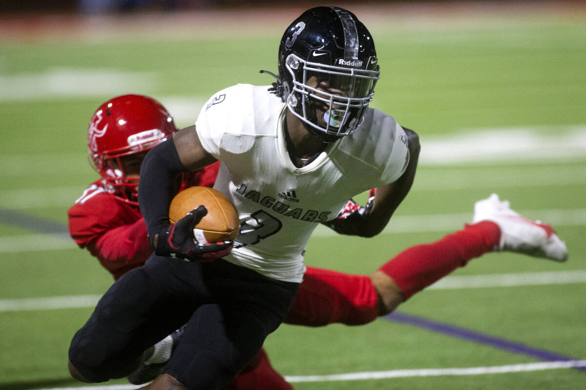 Arbor View's Jason Sermons (37) attempts to tackle Desert Pines' Lavon Brown (3) during a high ...