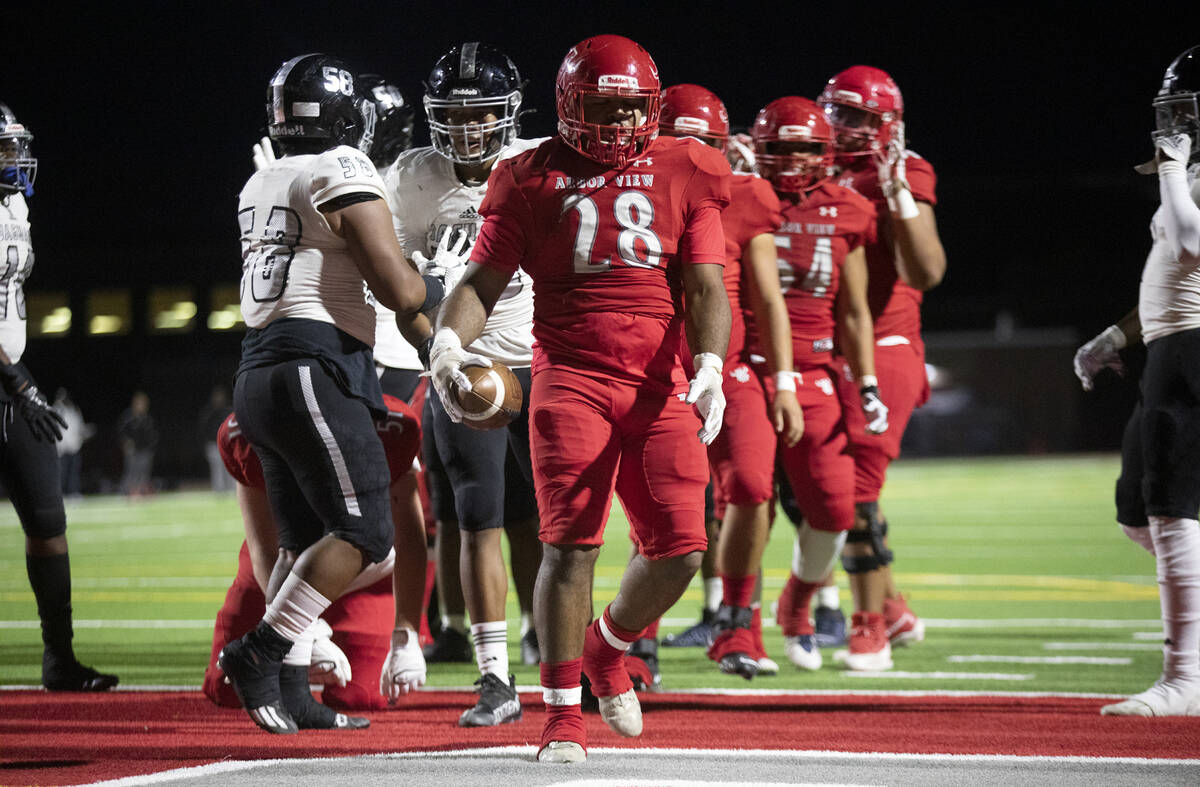 Arbor View's Richard Washington (28) reacts after scoring a touchdown against Desert Pines duri ...