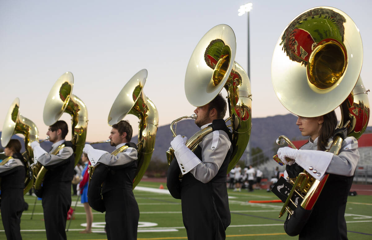 Tuba players in the Arbor View marching band warm up before their team takes the field at a hig ...