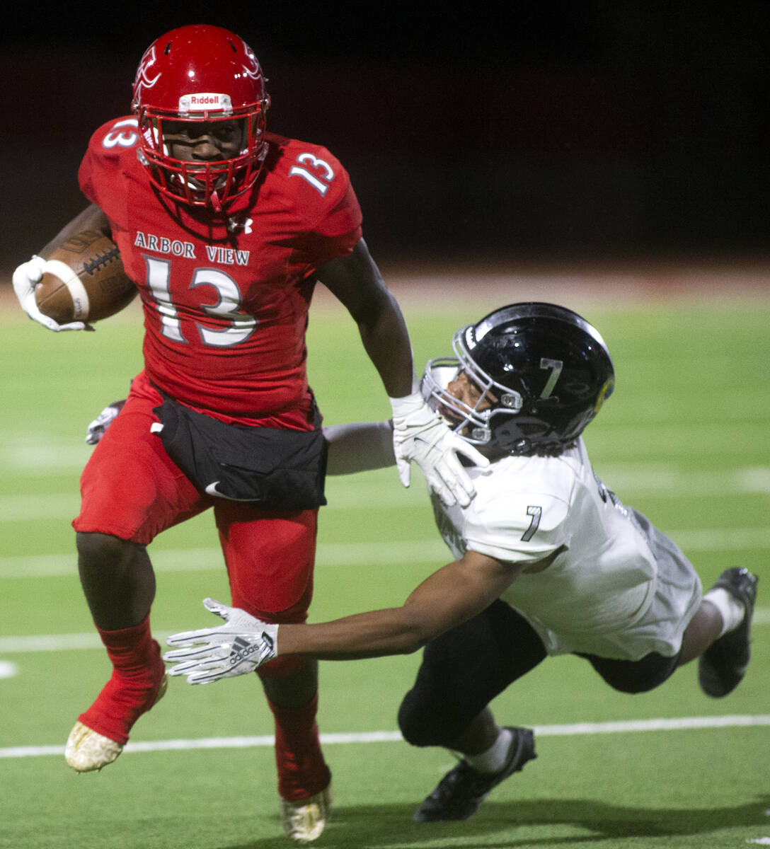 Arbor View's D'Andre Washington (13) outruns Desert Pines' Omar Ali (7) during a high school fo ...