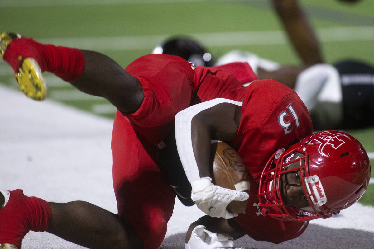 Arbor View's D'Andre Washington (13) tumbles into the sidelines after being tackled by Desert P ...