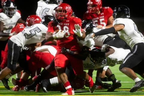 Arbor View's Richard Washington (28) makes it through several tackle attempts by Desert Pines d ...