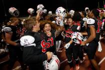 Liberty High School's players celebrate their victory against Legacy High School after a footba ...