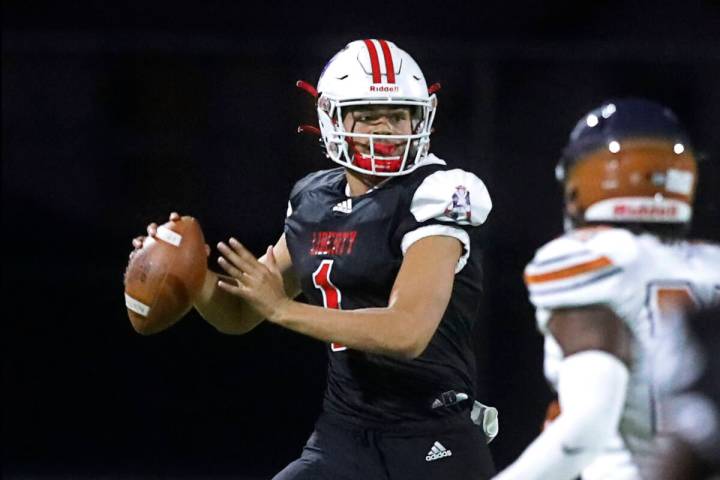 Liberty High School's quarterback Jayden Maiava (1) looks to throw the ball against Legacy High ...