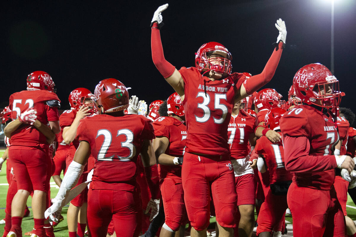 Arbor View players, including Jonathan Stites (35), celebrate a win against Desert Pines in a h ...