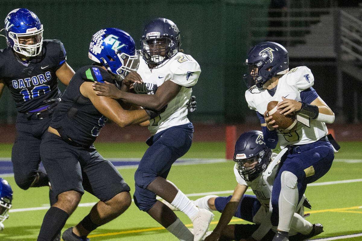 Foothill place holder LJ Wallick (3) picks up he ball and will throw a pass to a teammate for a ...