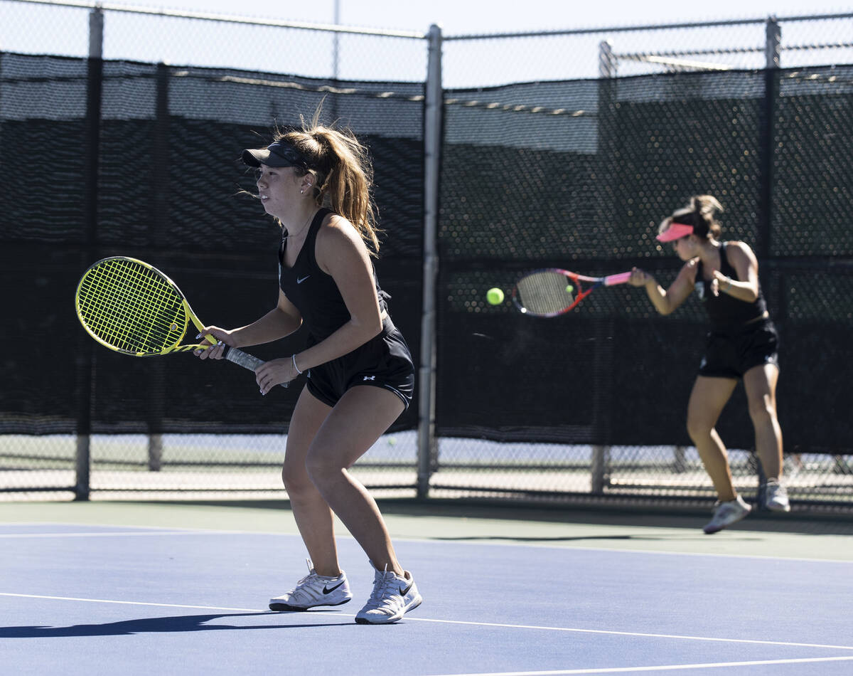 Palo HighÕs Palo Mandalay LeBarre returns the ball as Roxy Oklano, left, looks on during C ...