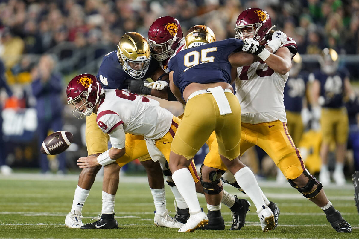 Southern California quarterback Kedon Slovis (9) fumbles the ball against Notre Dame in the fir ...