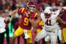 Southern California quarterback Kedon Slovis (9) runs during the first half of an NCAA college ...