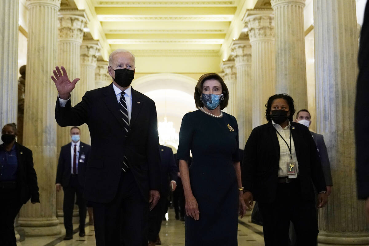 President Biden walks with House Speaker Nancy Pelosi on Capitol Hill in Washington, Thursday, ...