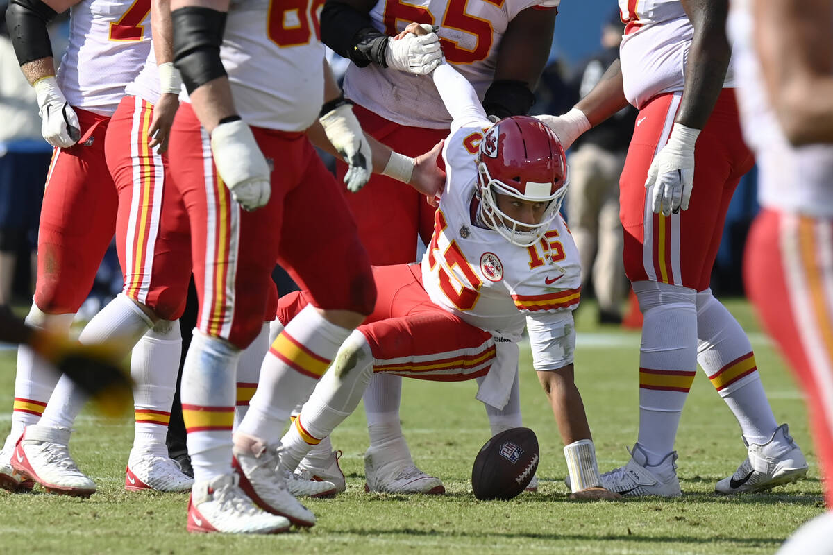 Kansas City Chiefs quarterback Patrick Mahomes (15) is helped up after being sacked by the Tenn ...